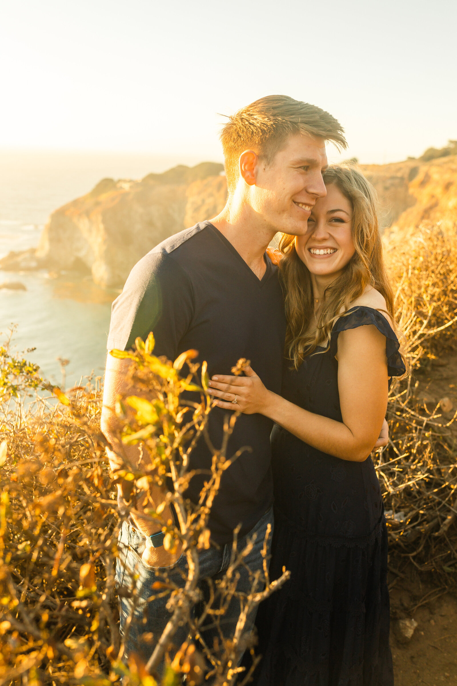 A couple poses for their engagement photos in Big Sur, California.