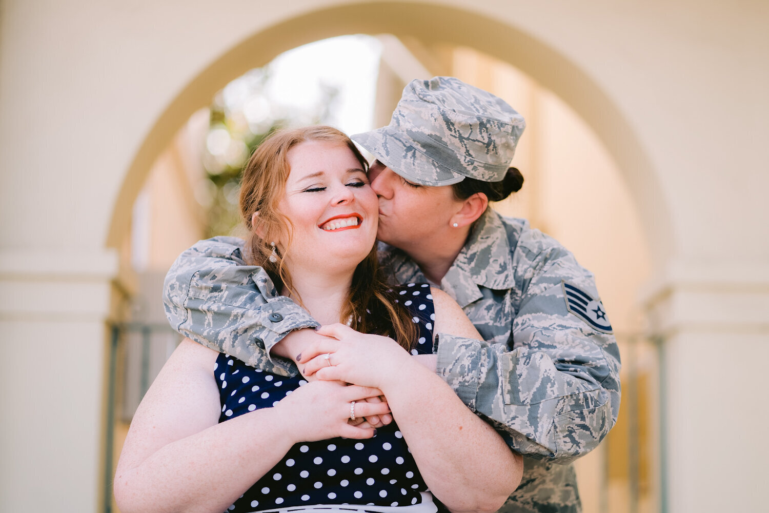 Two women embrace and  one woman is in air force uniform