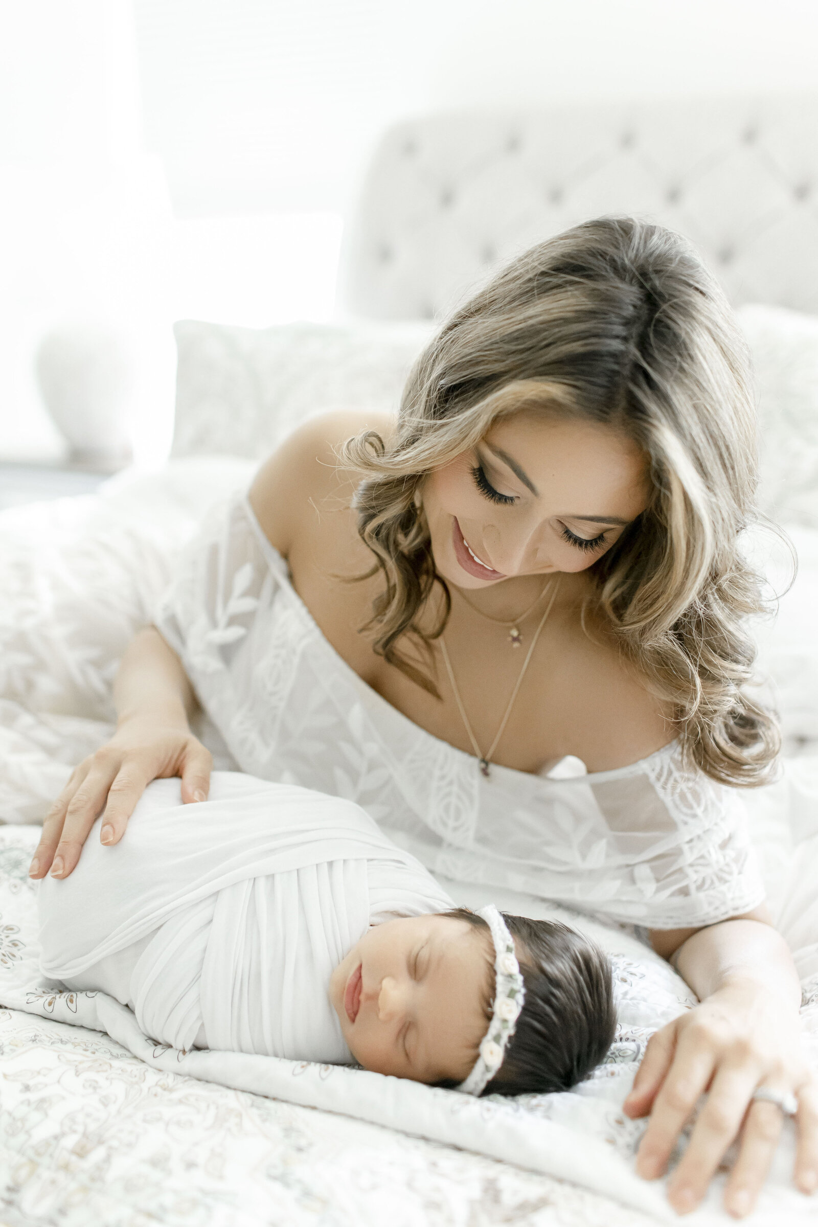 mom smiling at her newborn baby taken by nj newborn photographer