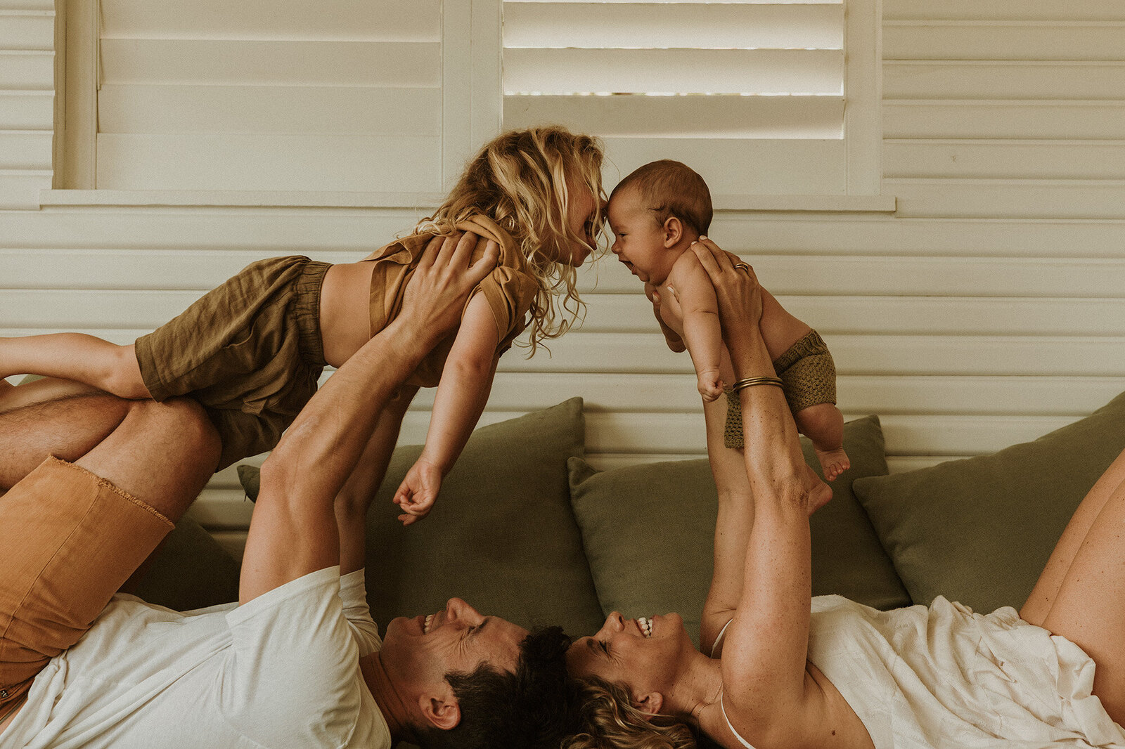 Mum and dad holding kids in the air