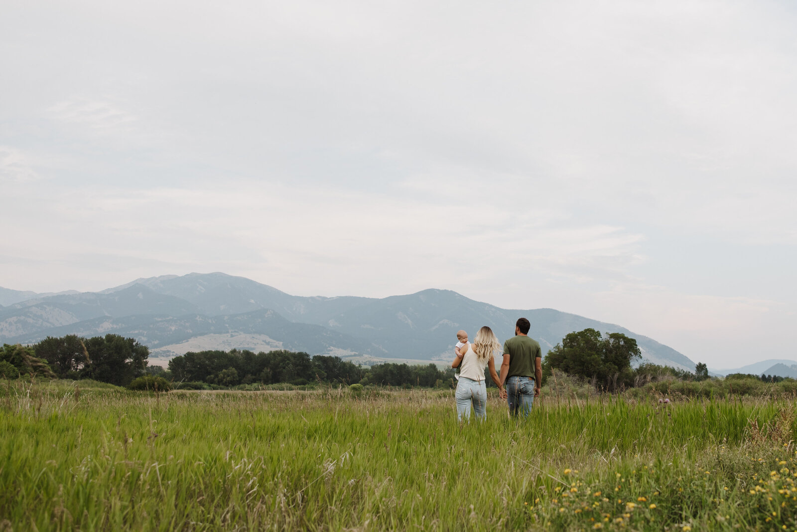Photo of a beautiful family walking towards the bridger mountains in Bozeman, MT