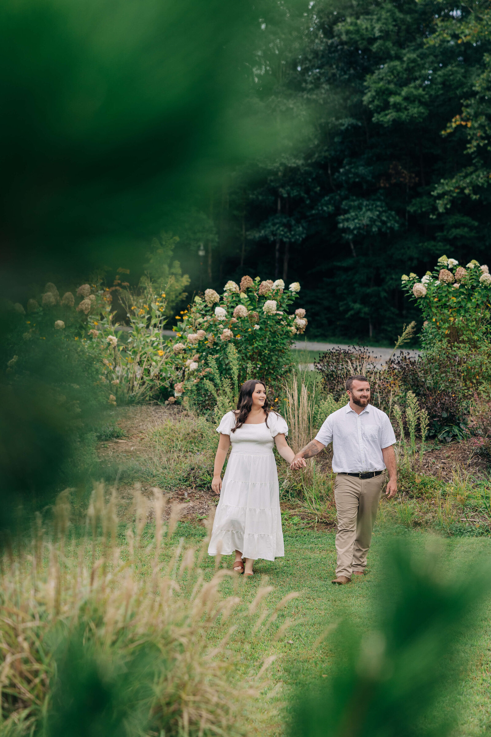 Couple-walking-in-field-The-Little-Chapel