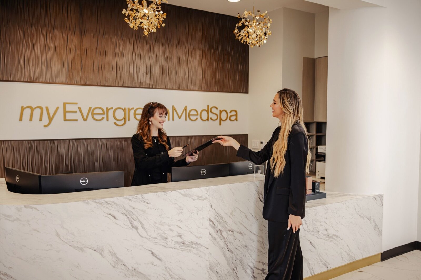 Front desk at MyEvergreen MedSpa with a team member greeting a guest