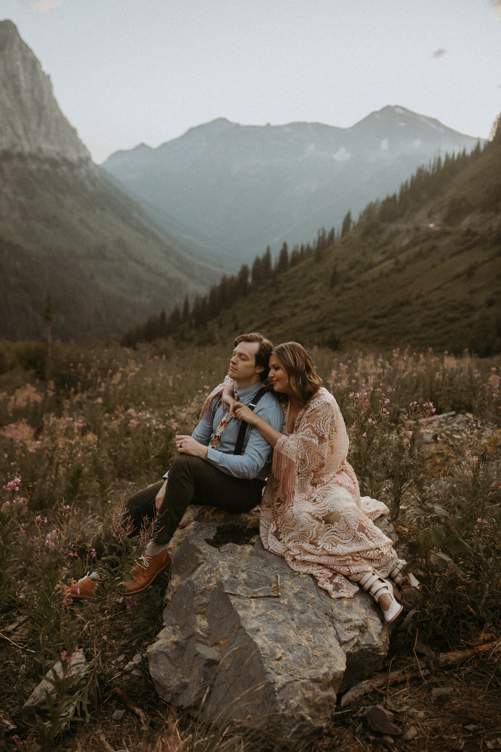 couple sitting on a rock during their glacier national park elopement