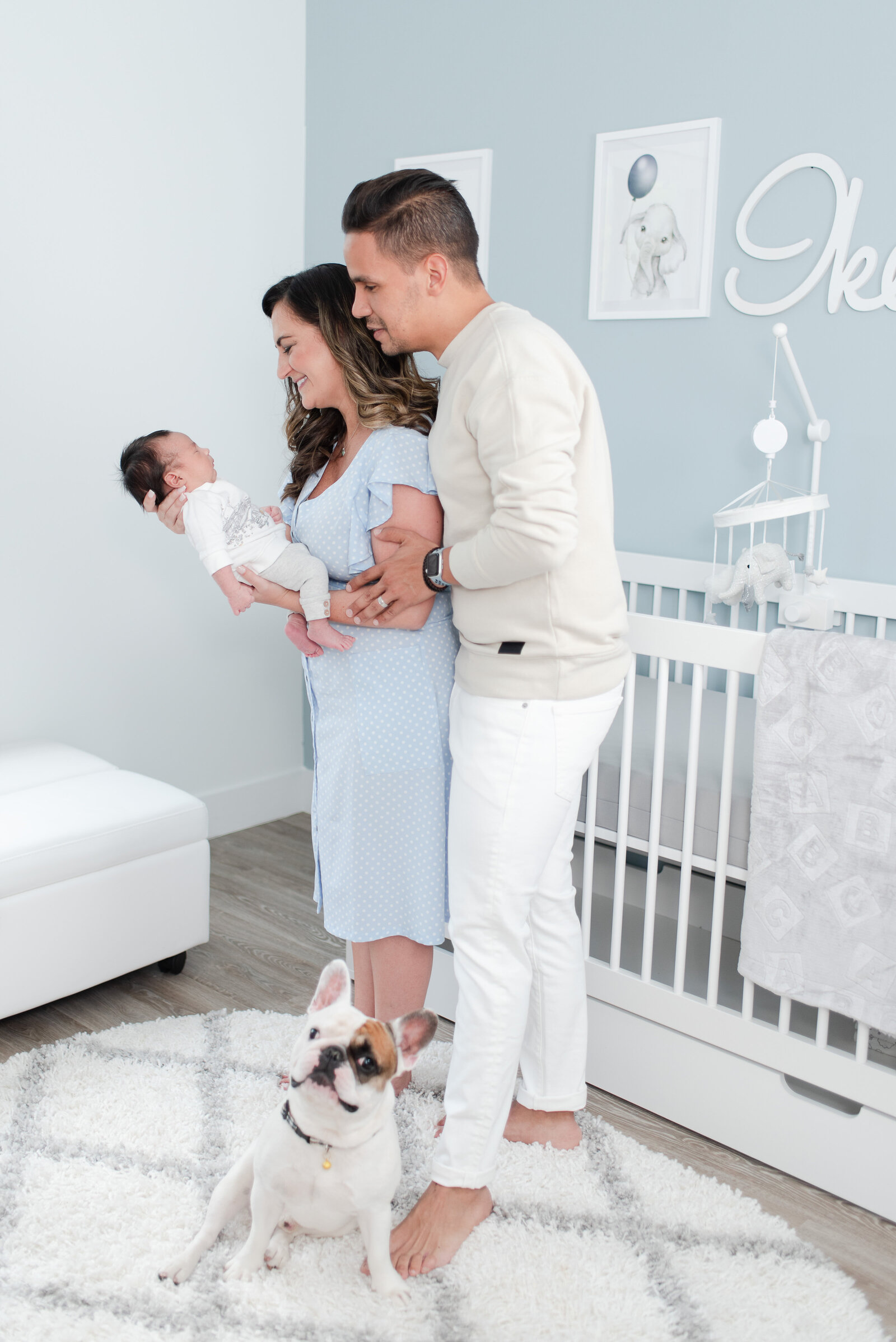 mom dad frenchie puppy and newborn baby boy session in blue animal themed nursery in doral fl by Miami Lifestyle Photographers David and Meivys of MSP Photography
