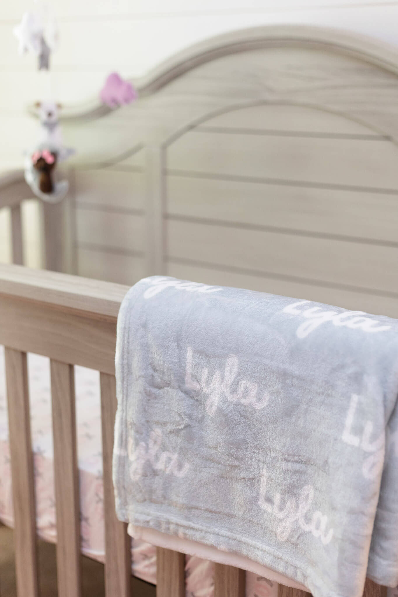 A closeup of a blanket hanging on the side of a crib in a Manassas nursery.
