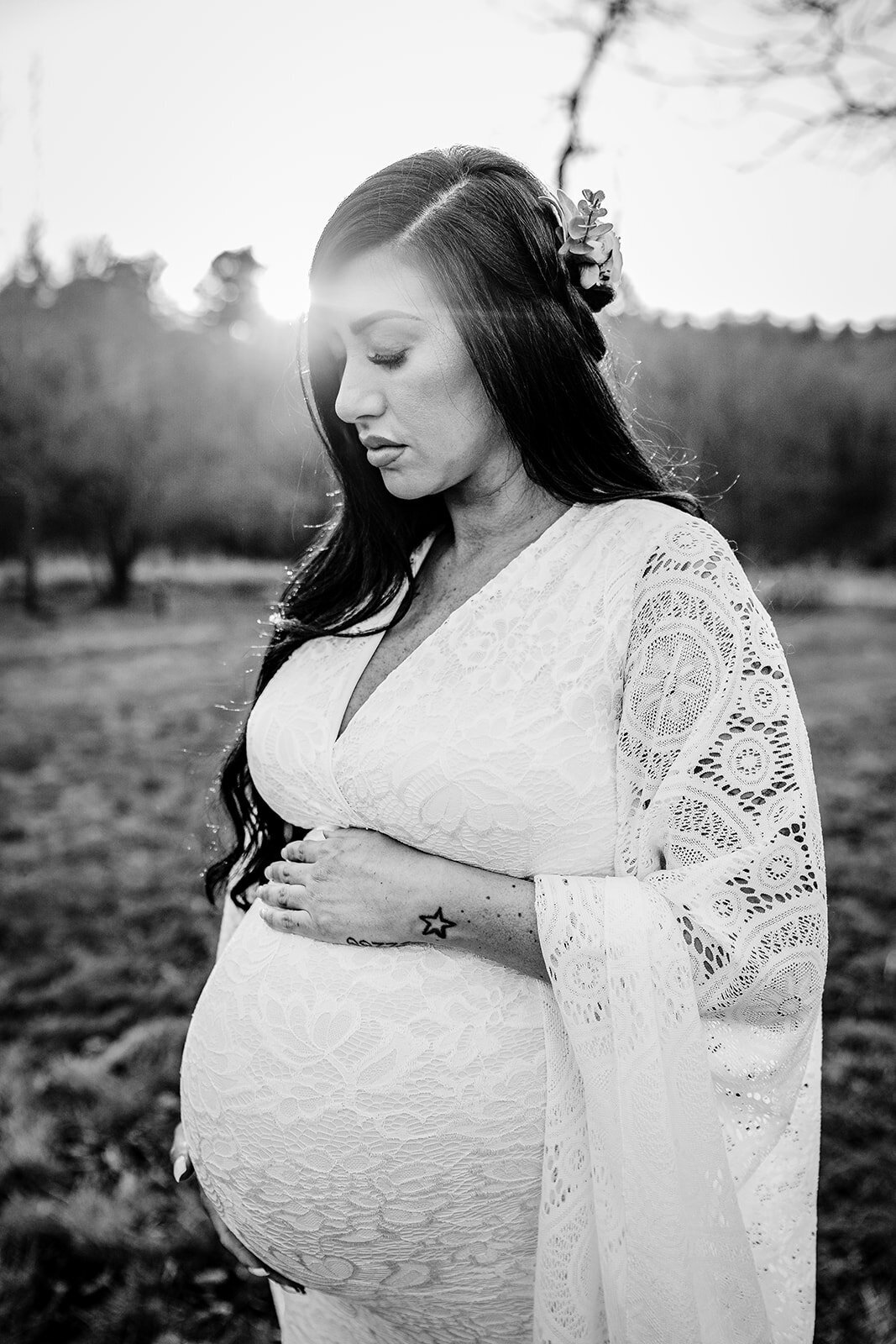 black and white portrait of pregnant woman in a lace dress