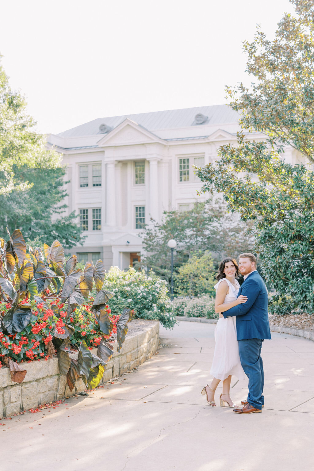 Couple smiles as they get engaged in downtown Atlanta by elephant leaf plants