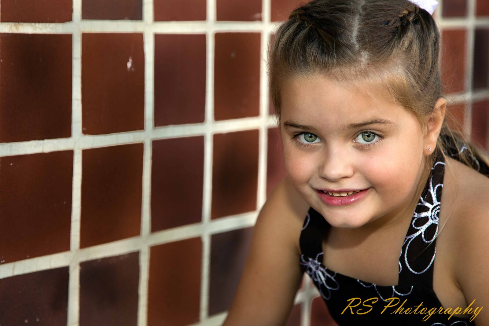 Young lady posing with brick wall background with Ron Schroll Photography in Charlotte, NC