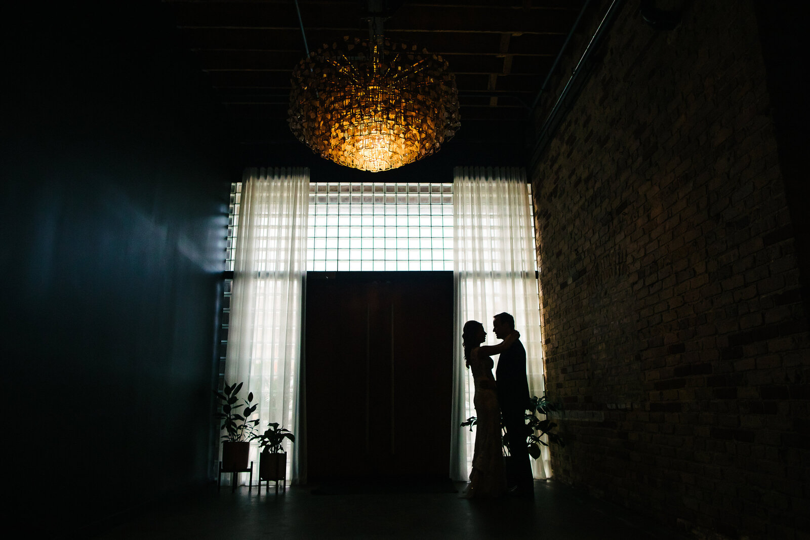 Bride and Groom Posing In Front of Entryway