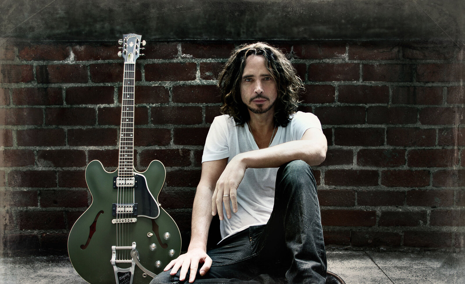 Chris Cornell musician portrait Beverly Hills sitting against brick wall with Signature ES-335 Gibson Guitar