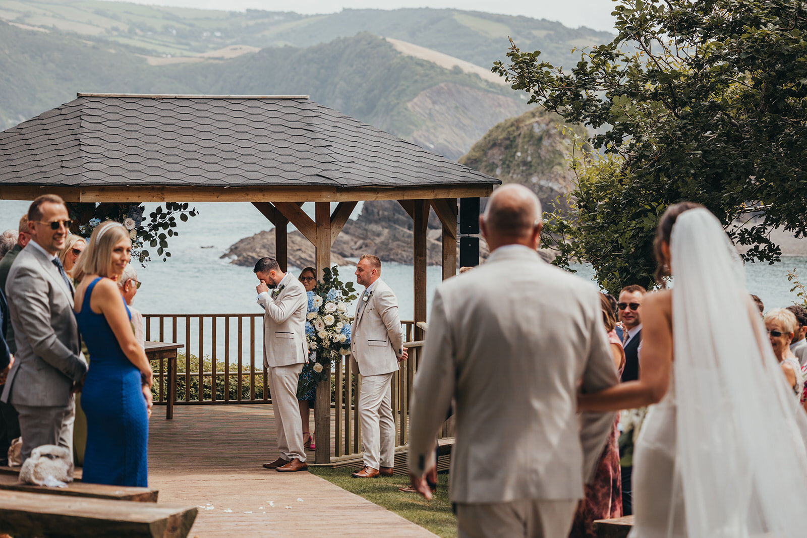 groom cries as his bride arrives