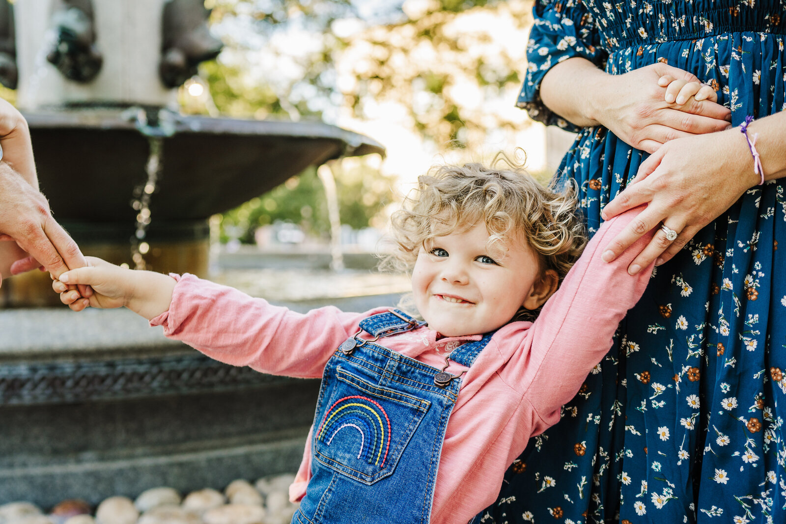 girl in jean overalls smiles at camera