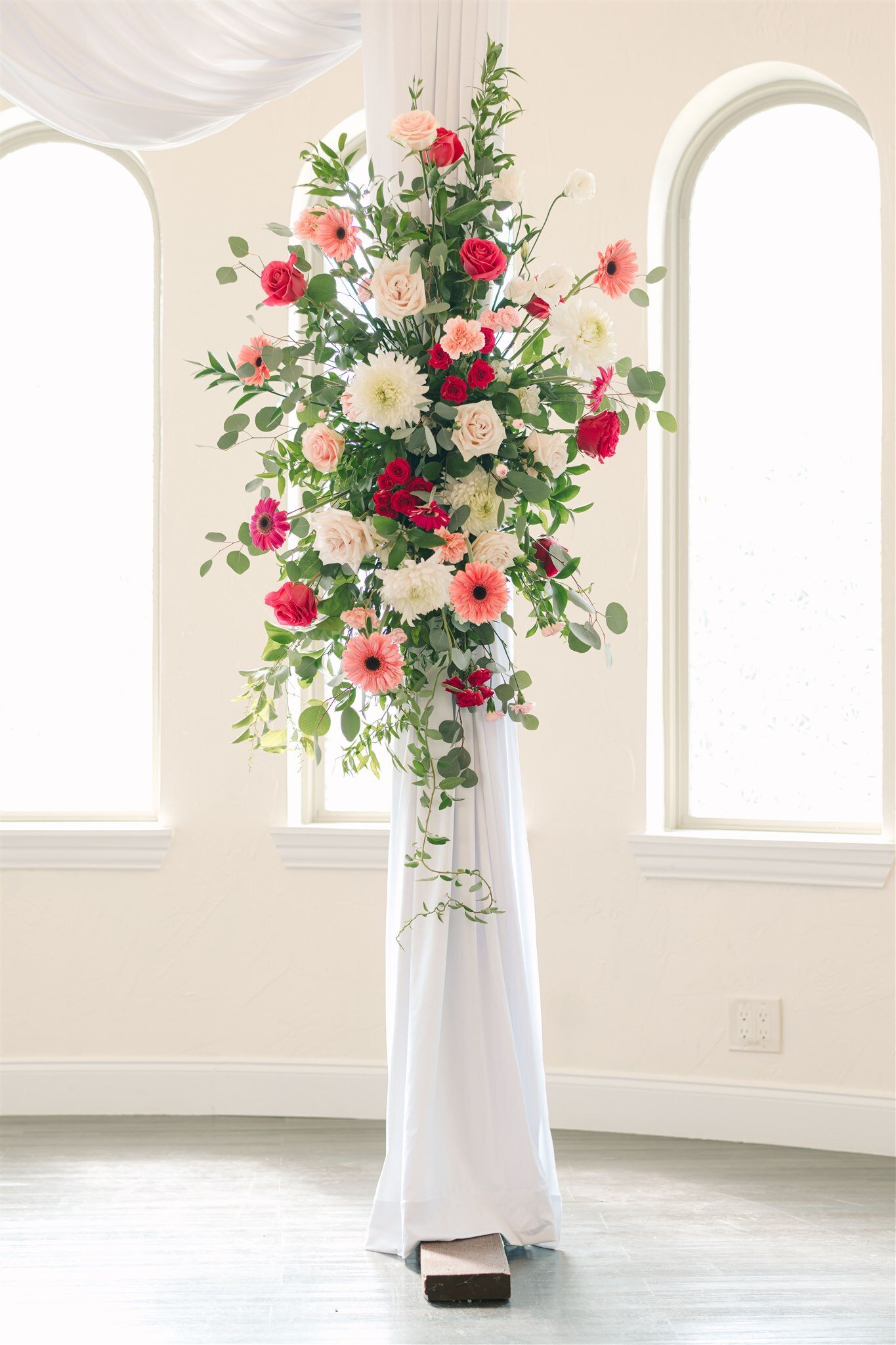 luxury wedding flower display with pink and red flowers