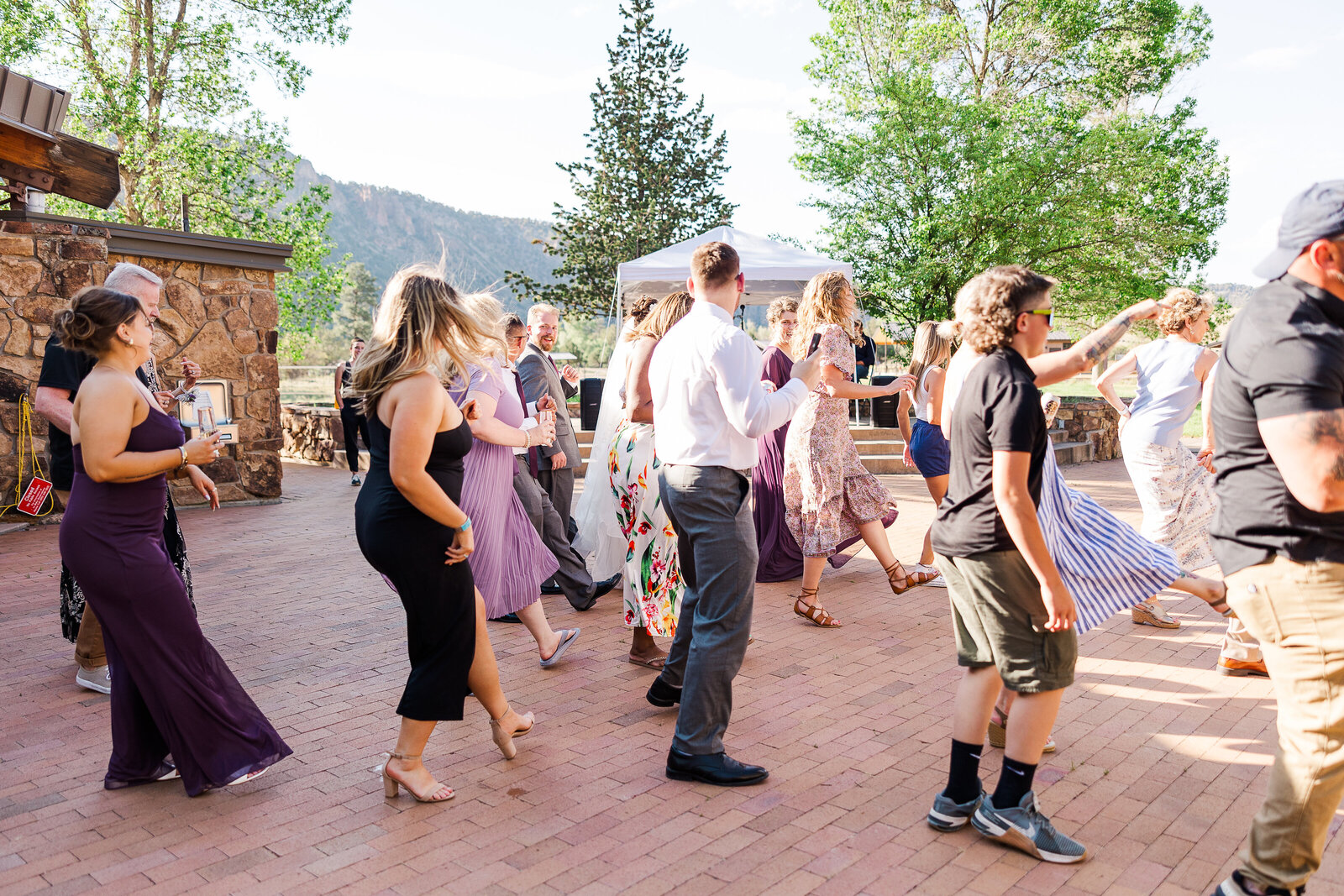 Different angle of wedding guests dancing and celebrating at a Ridgway State Park wedding reception