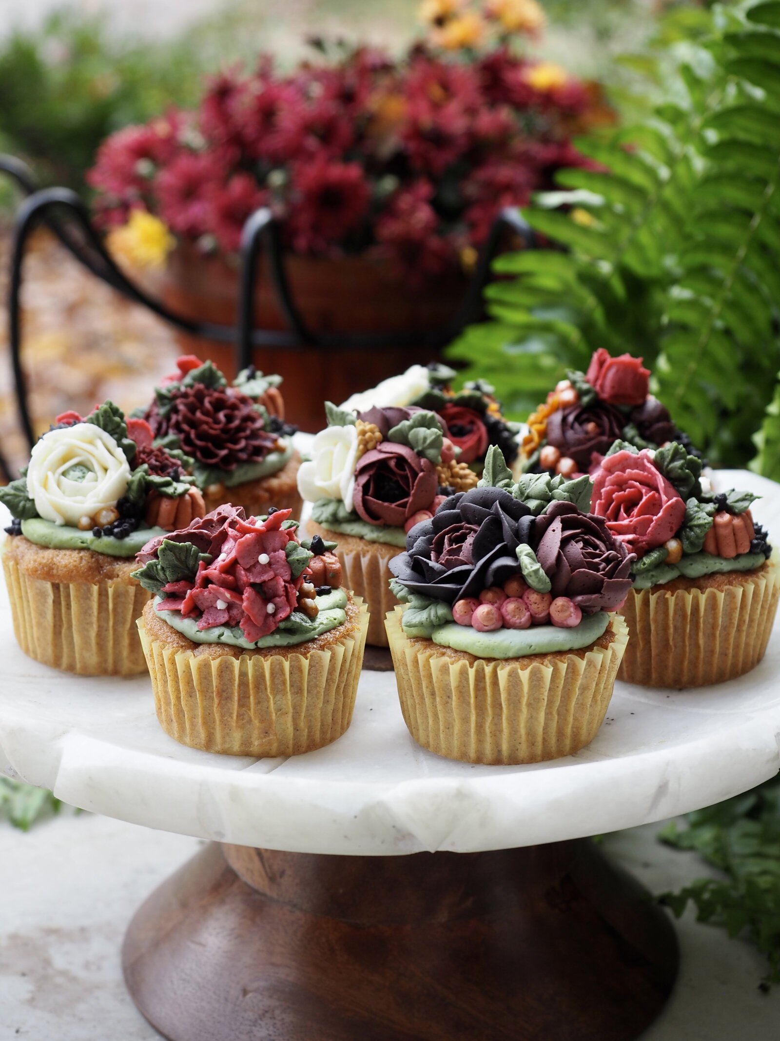 Fall inspired floral buttercream cupcakes on a stand