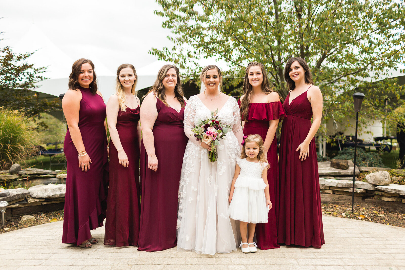 bridal party smiling for portrait at rustic wedding with burgandy dresses ohio