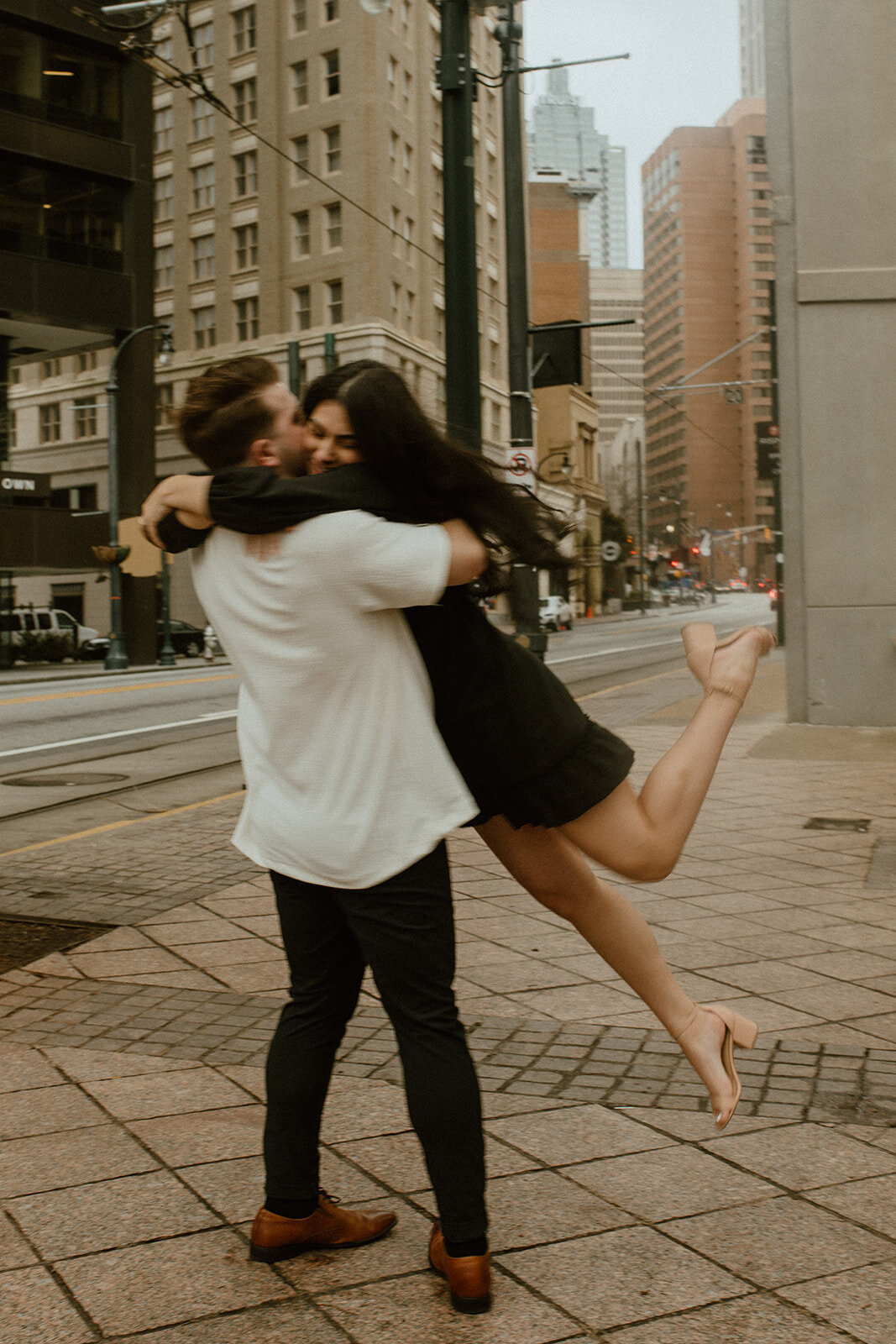 engagement photos spinning in street