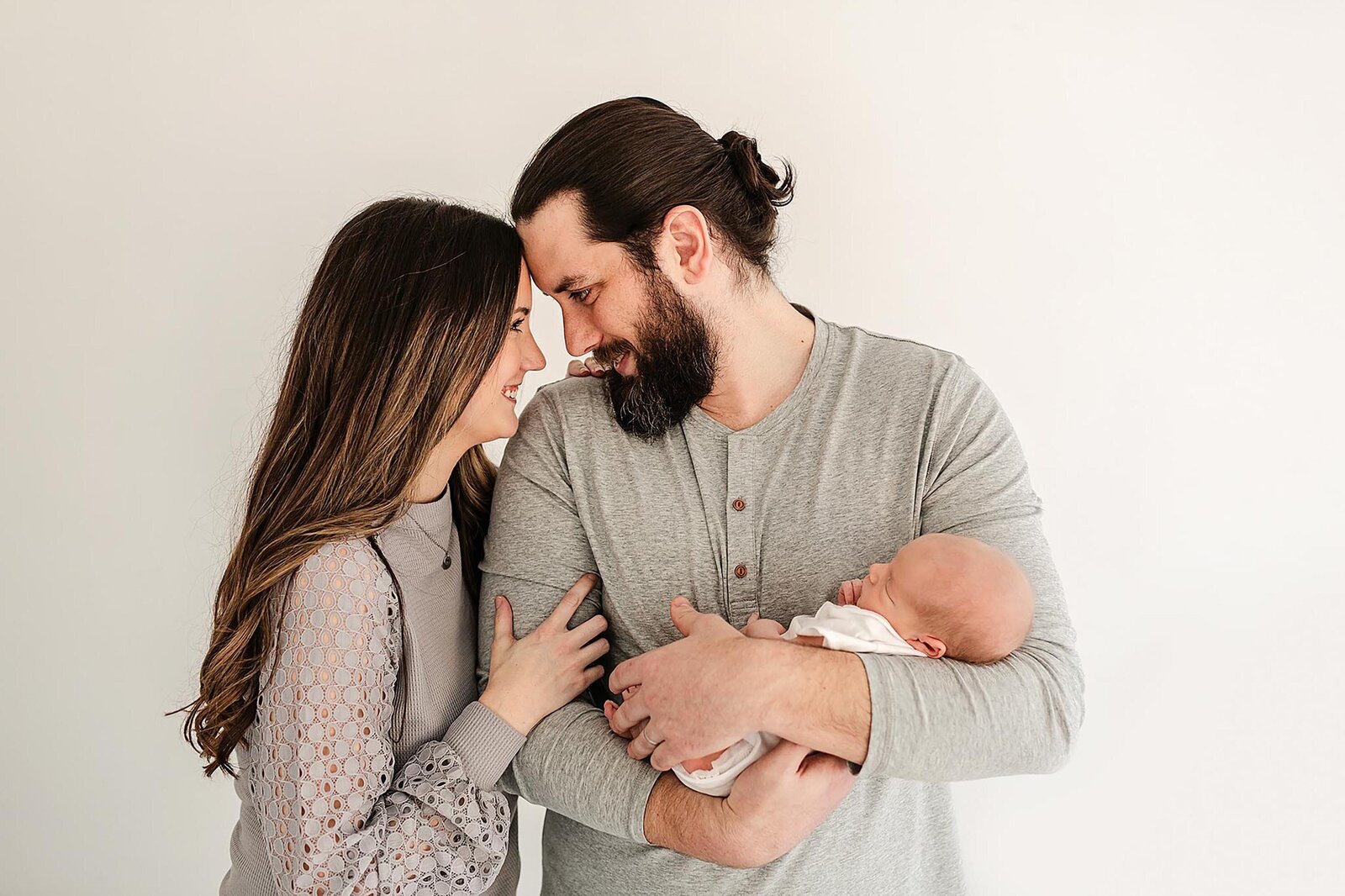 new mom and dad holding their newborn baby