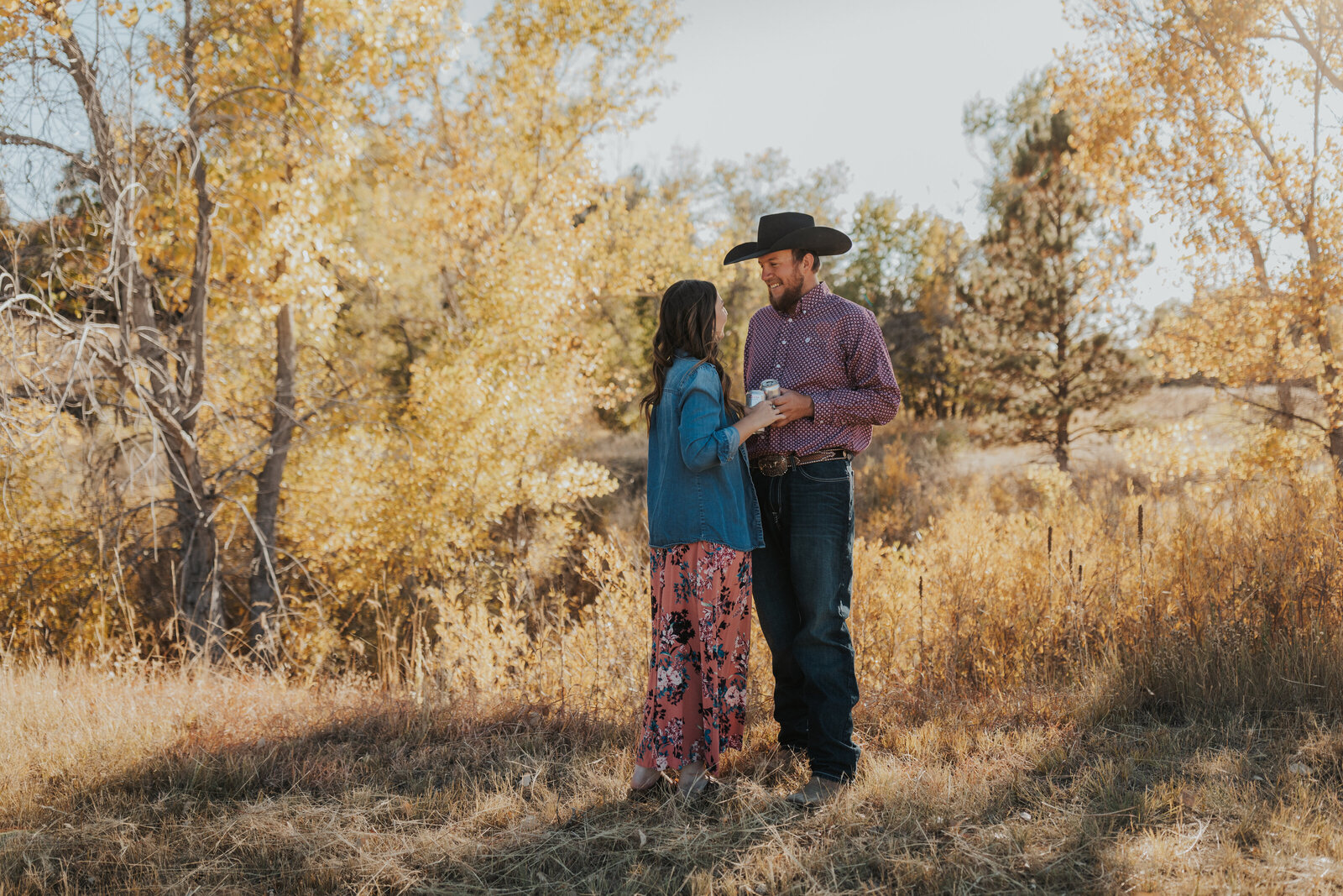 Couple shares beer and laughs during golden hour