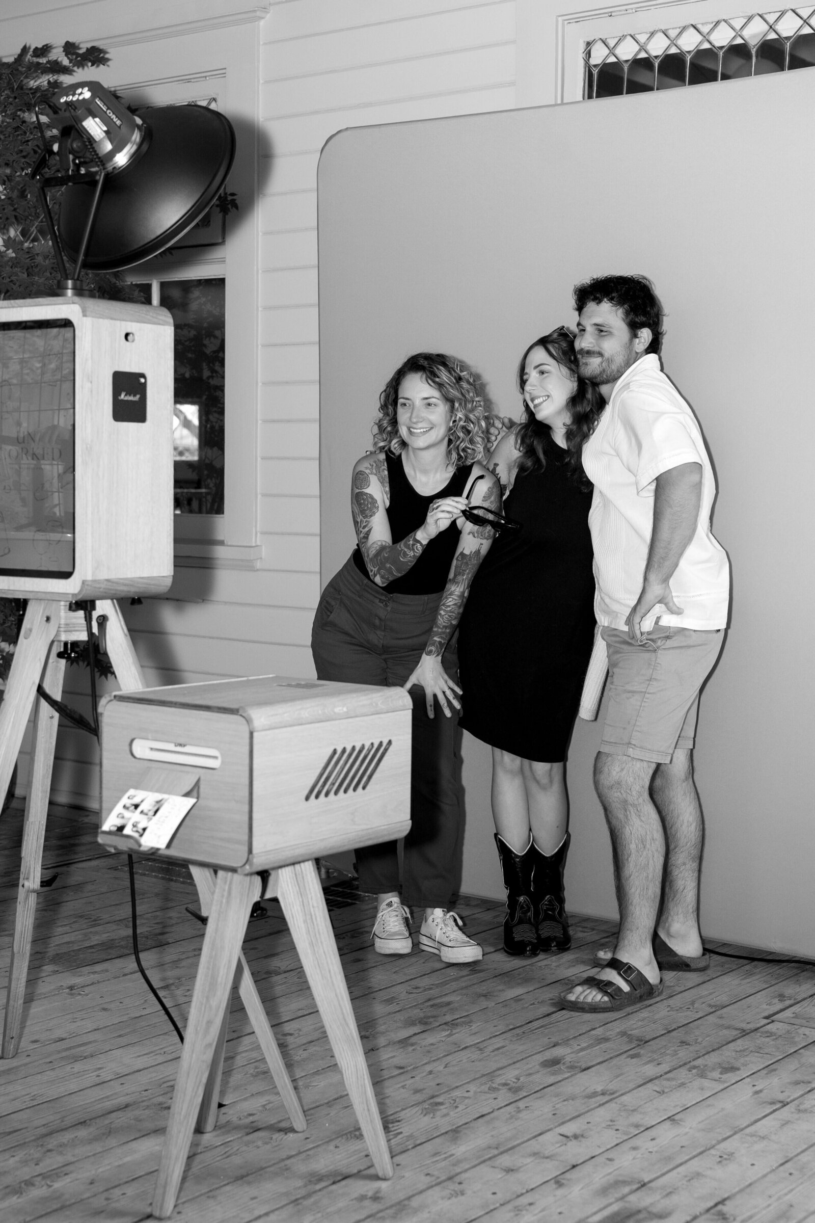 Friends enjoying our Signature Oak photo booth. Los Angeles luxury photo booth rental.