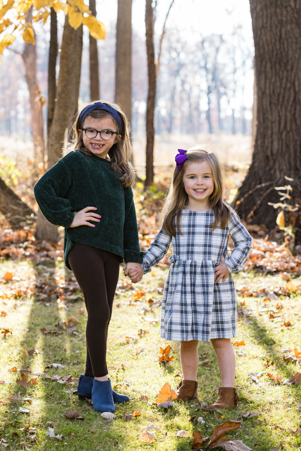 Two girls standing and holding each other's hand