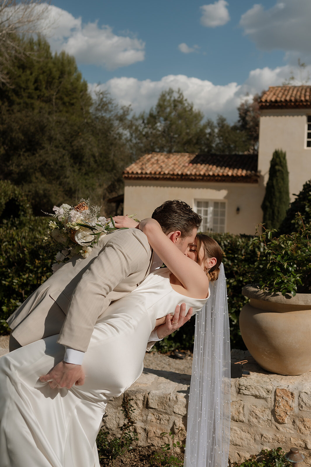bride and groom kissing during tuscan elopement