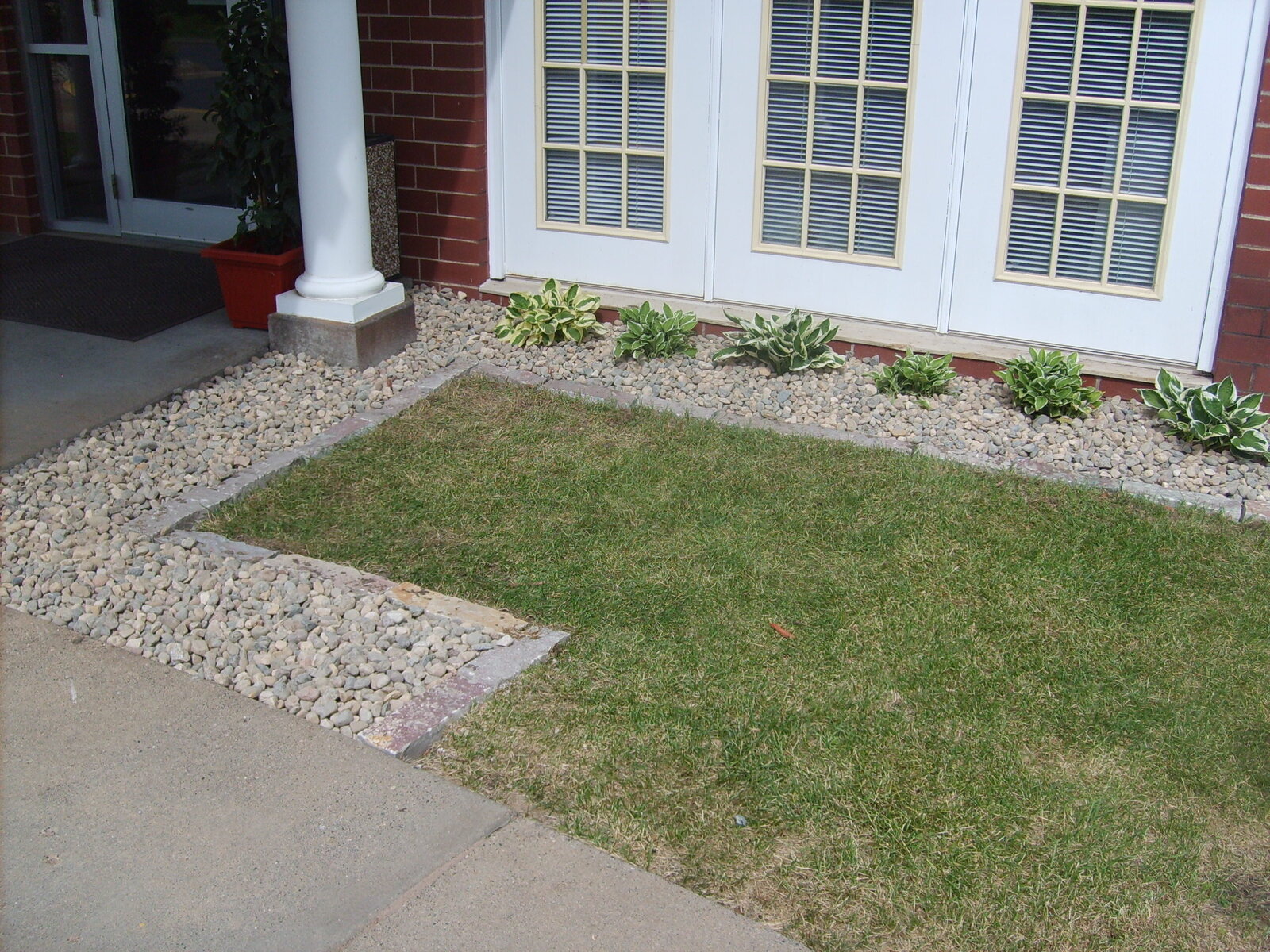 commercial landscaping with hostas and rocks