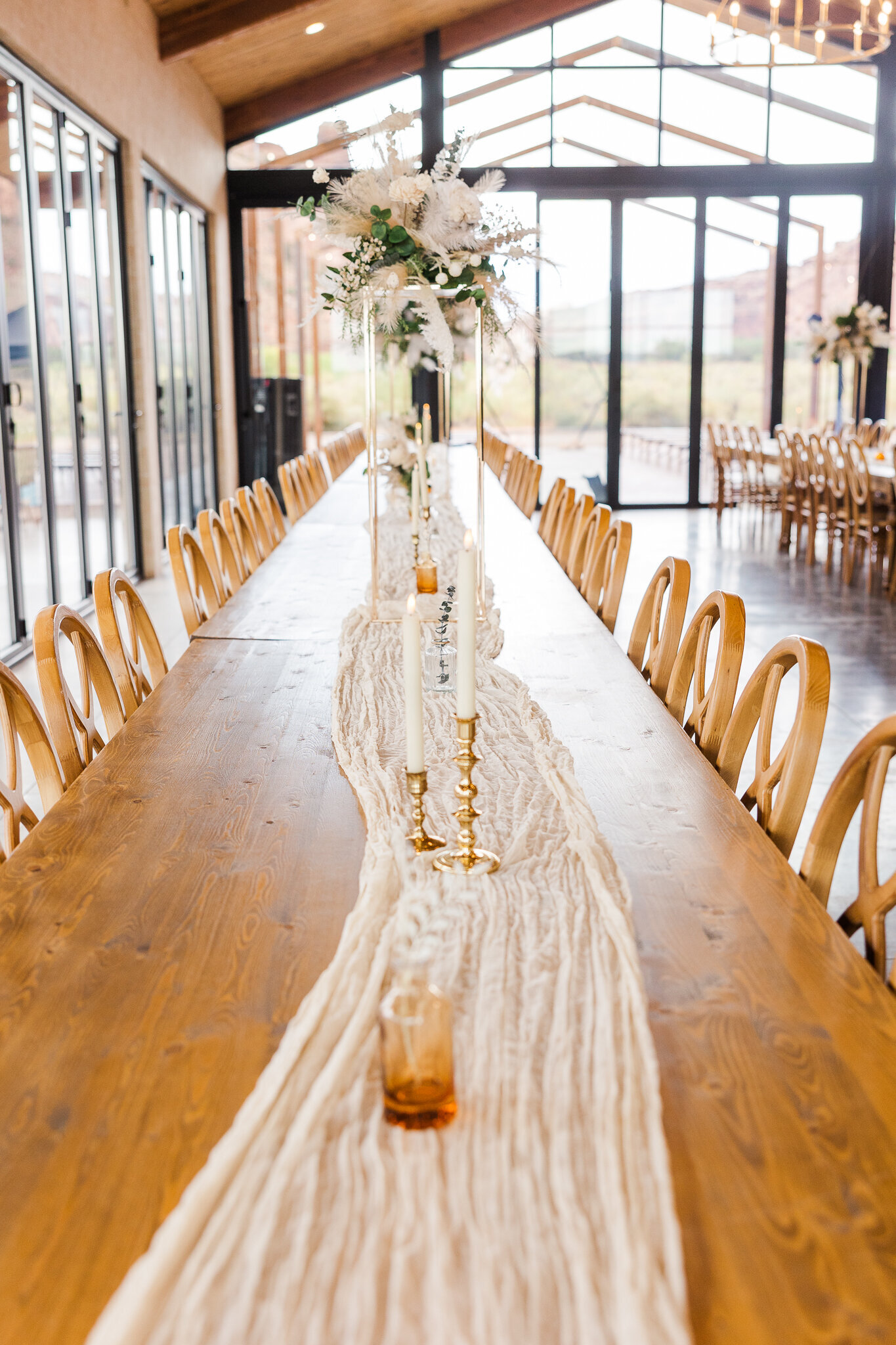 Wooden table set for wedding with white neutral decorations in Utah