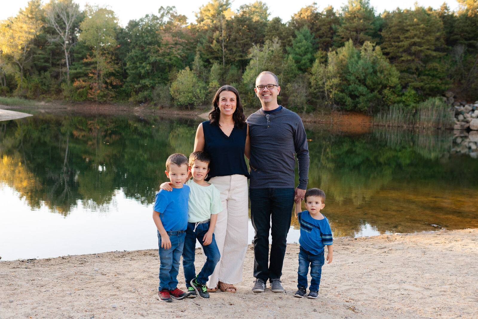 family in front of pond
