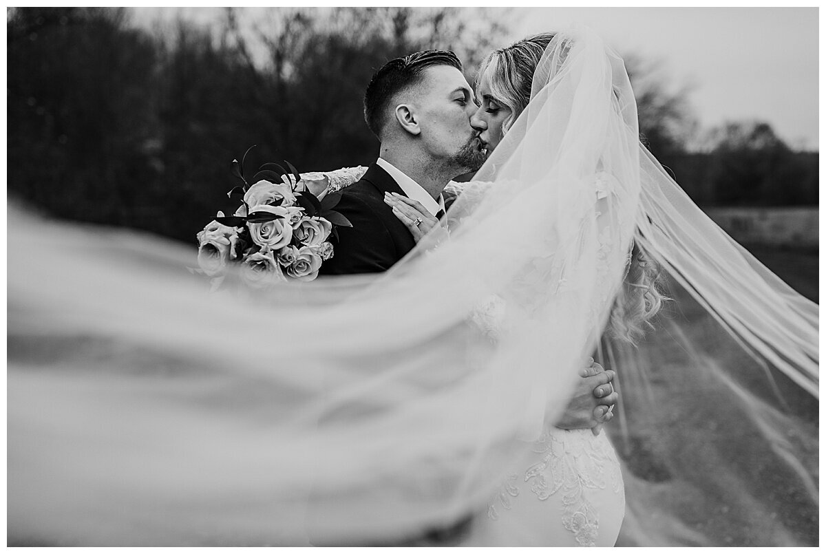 Black and white veil photo with bride and groom