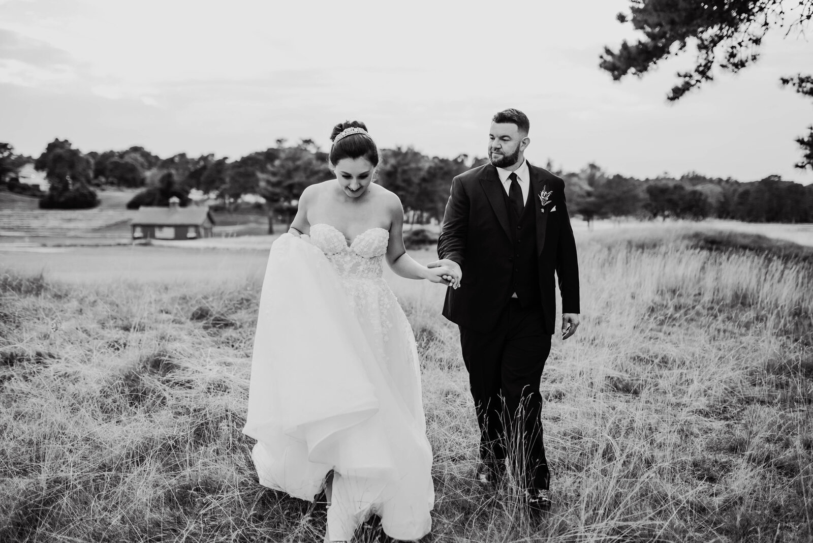 black and white wedding photos of bride and groom holding hands