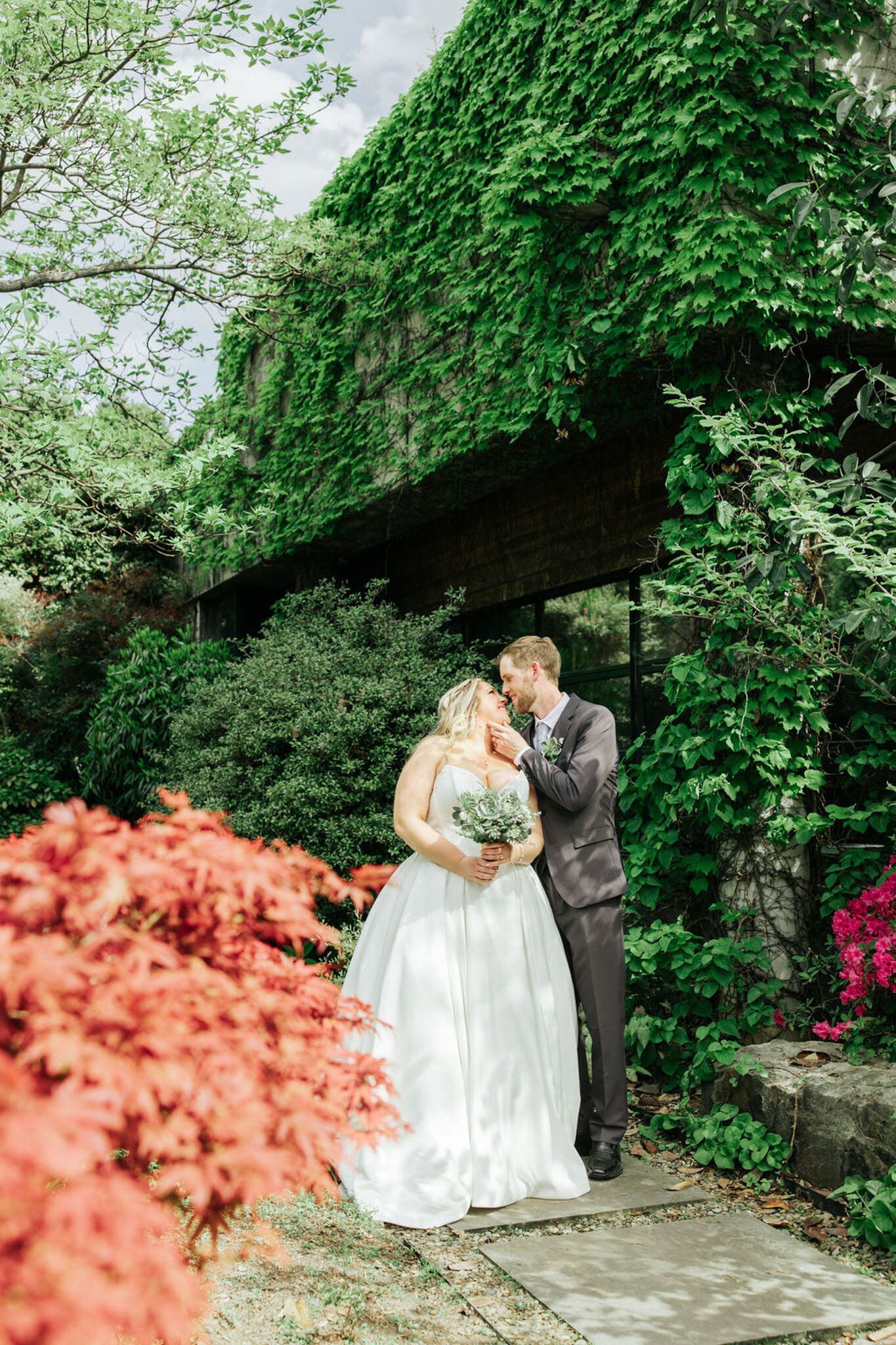 Bride and groom kissing in an outdoor setting