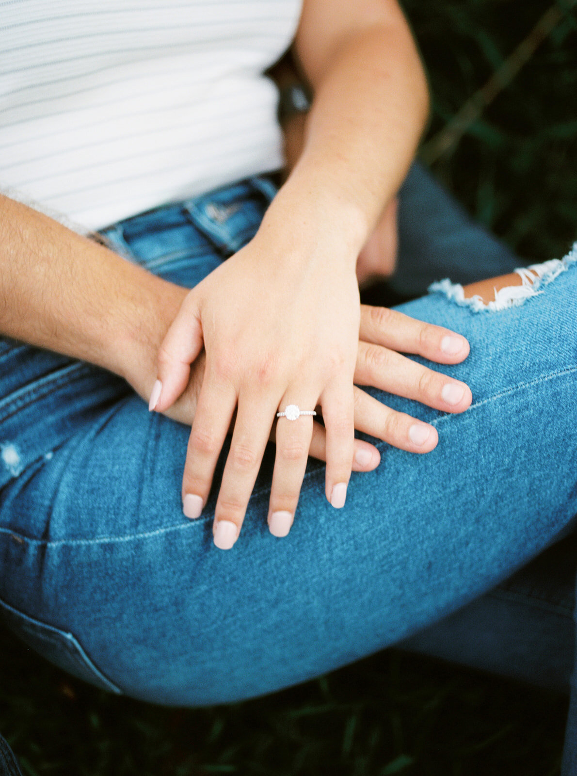 hands sit on bride to be jeans