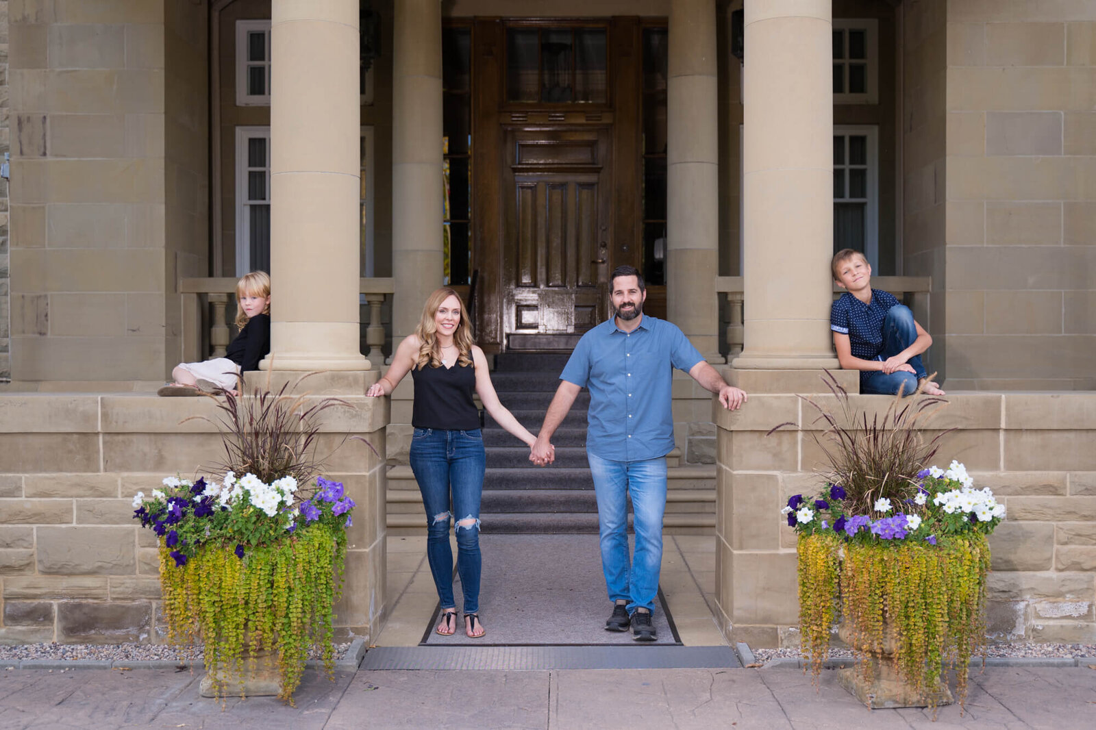 family of 4 photoshoot,. posed in front steps of Alberta Government house
