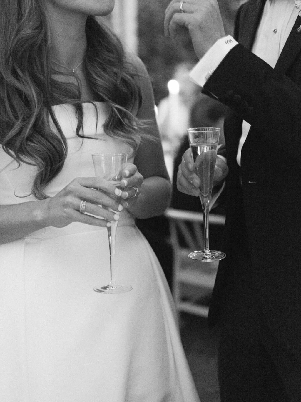 bride and groom holding champagne glasses at Alys beach wedding