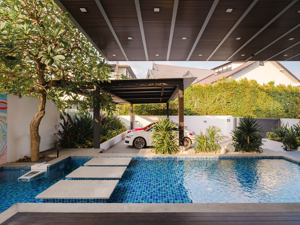 two cars parked in driveway and water feature pool area