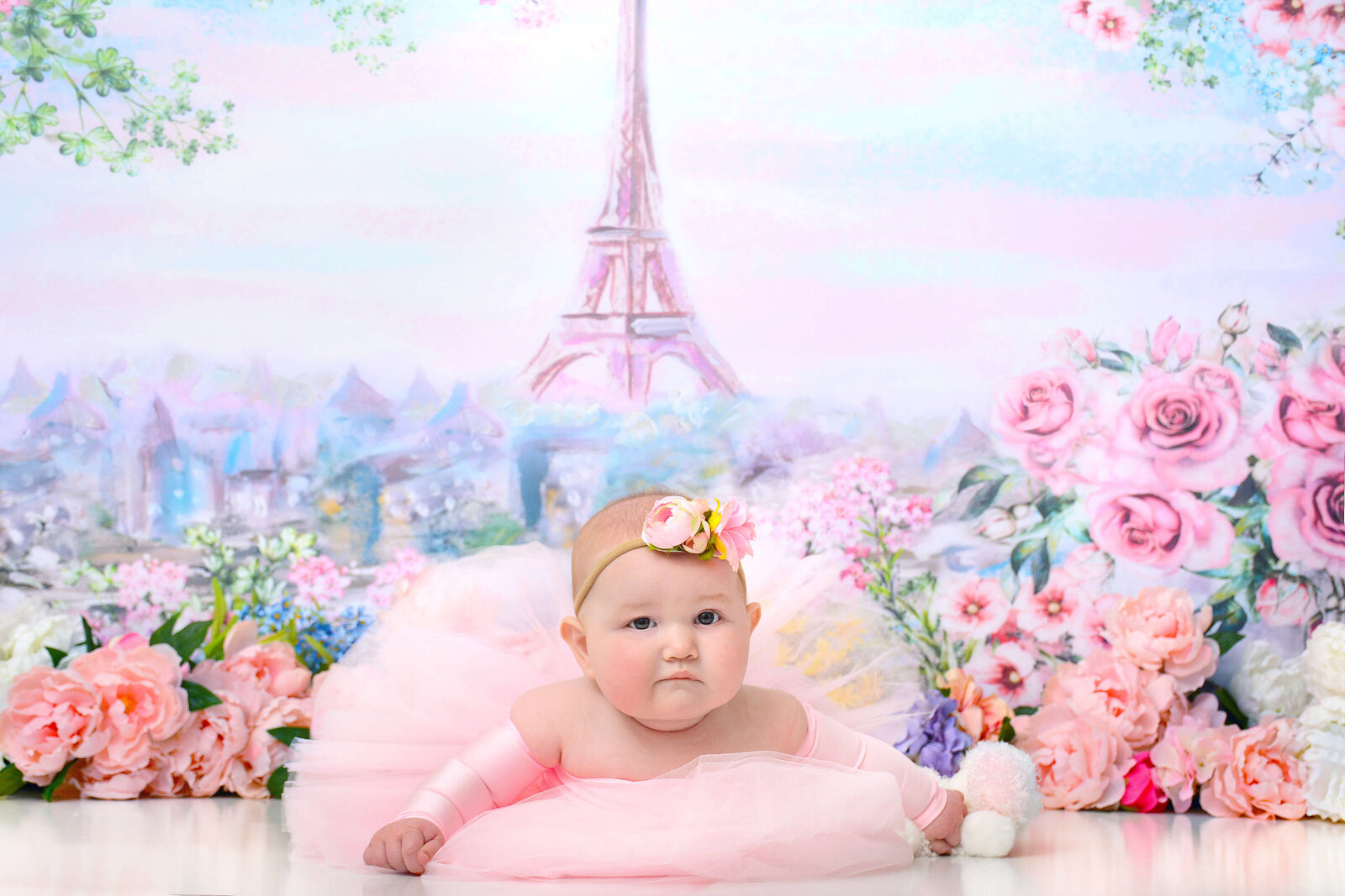 girl smiles at her paris themed half birthday photoshoot