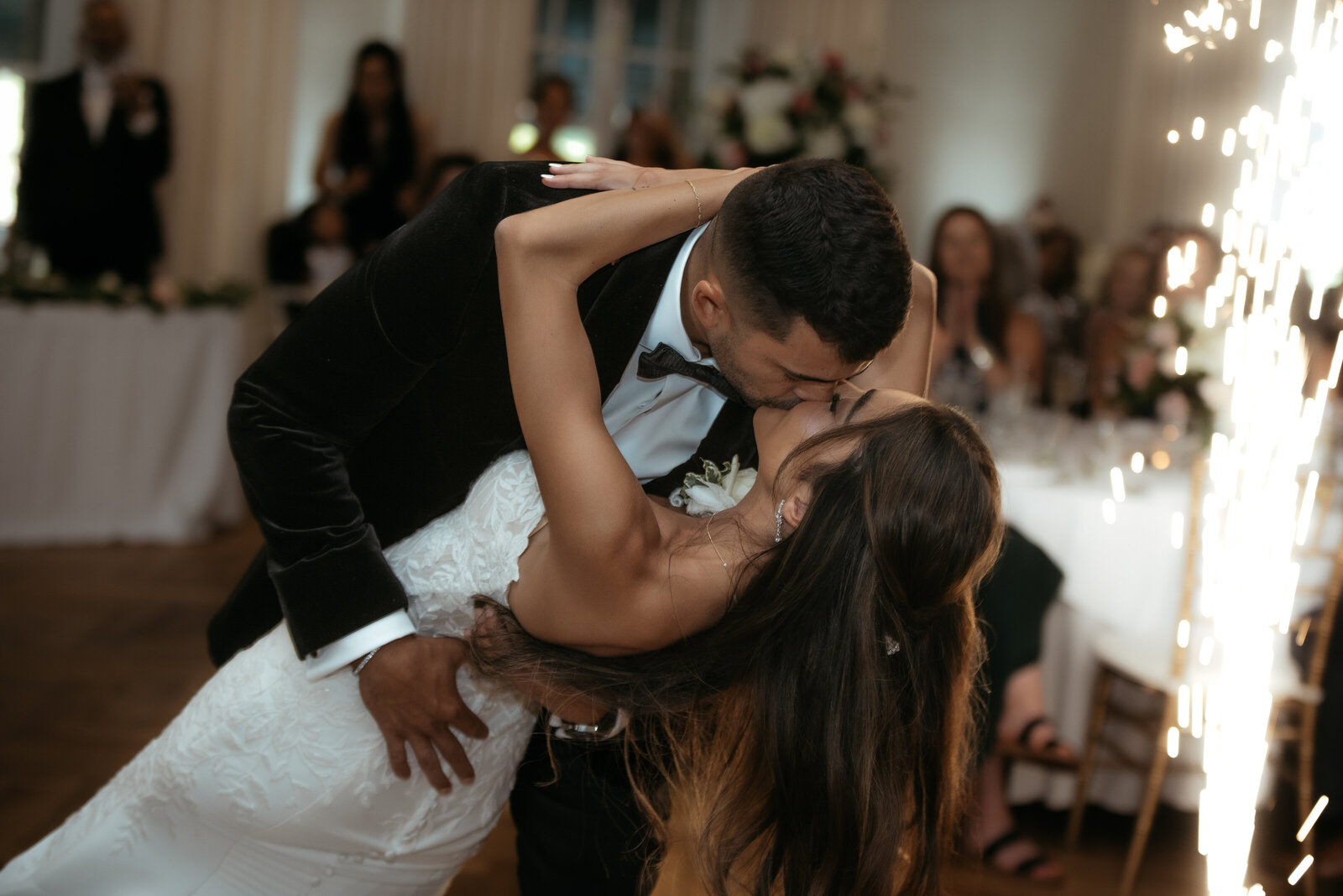 Cold sparklers fire as the bride and groom dip and kiss during their first dance at Longue Vue Country Club.