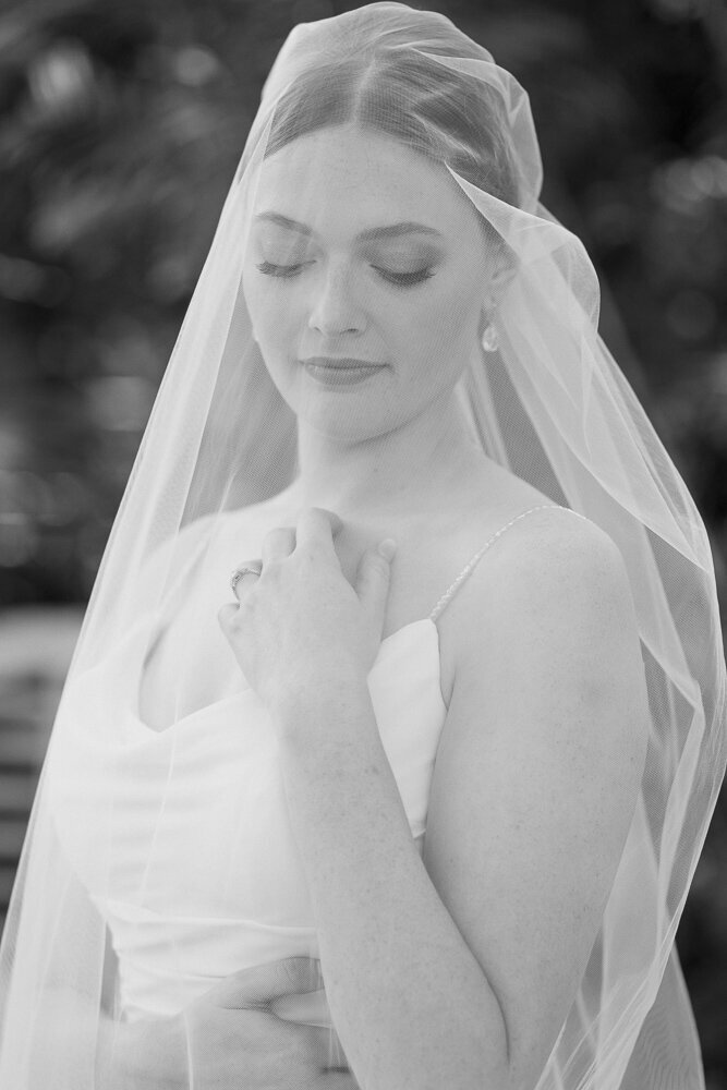 catholic bride posing in her wedding dress and veil