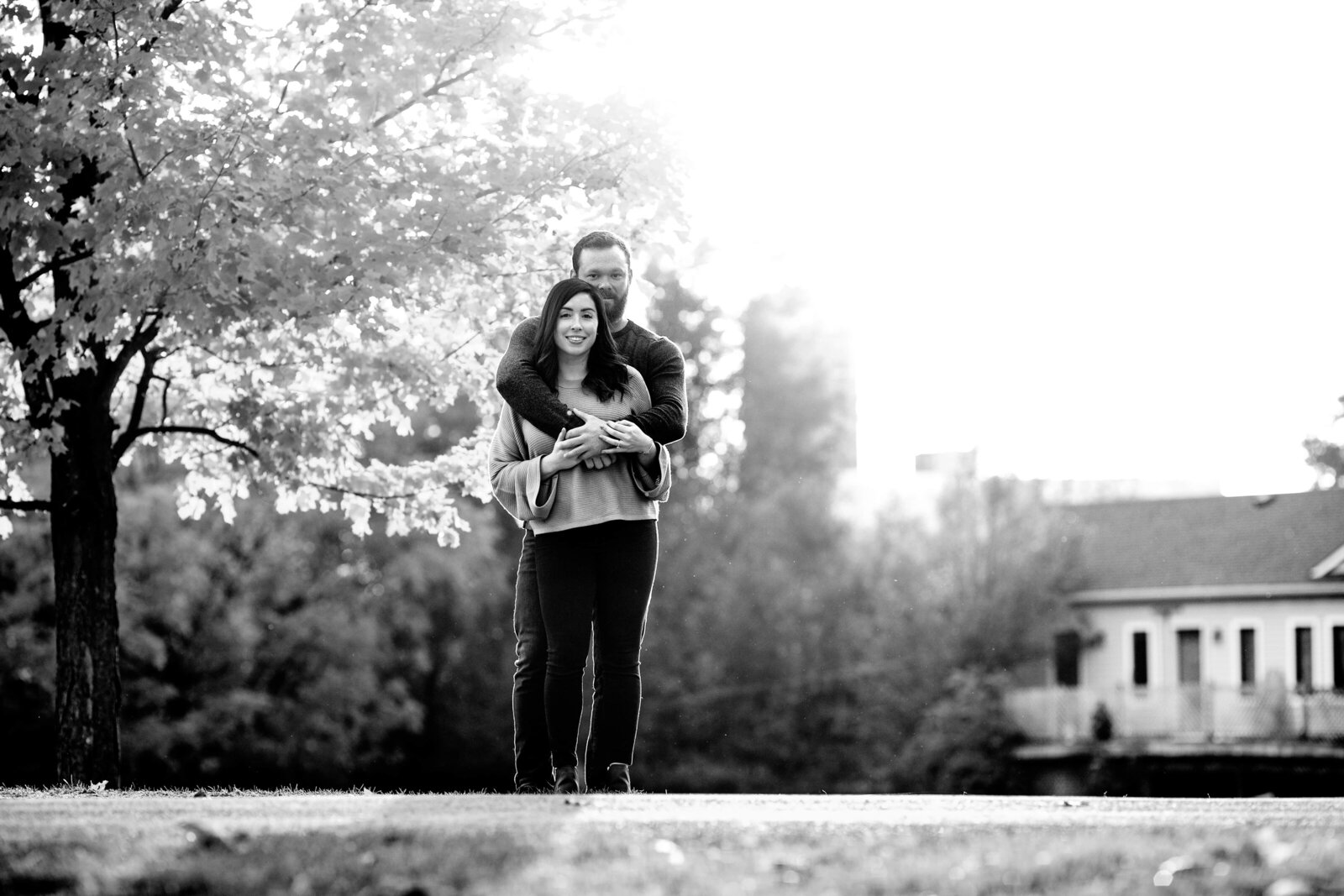 Couple embrace at Pinehurst Lake engagement session