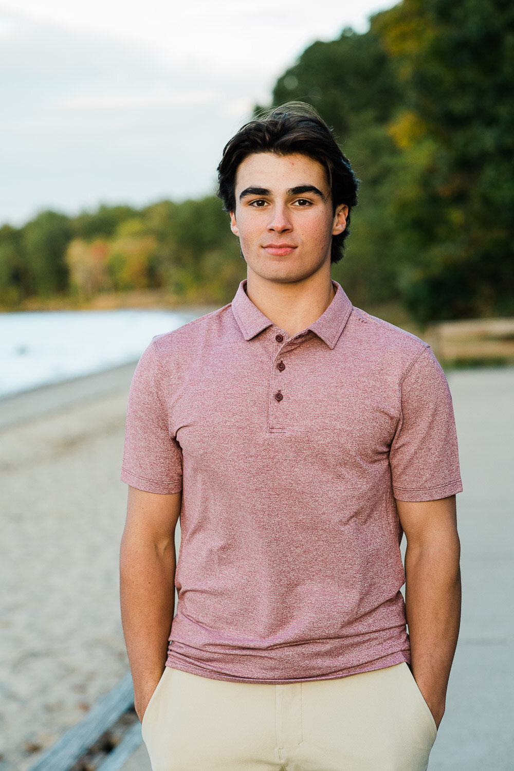 senior boy hands in pockets  at beach