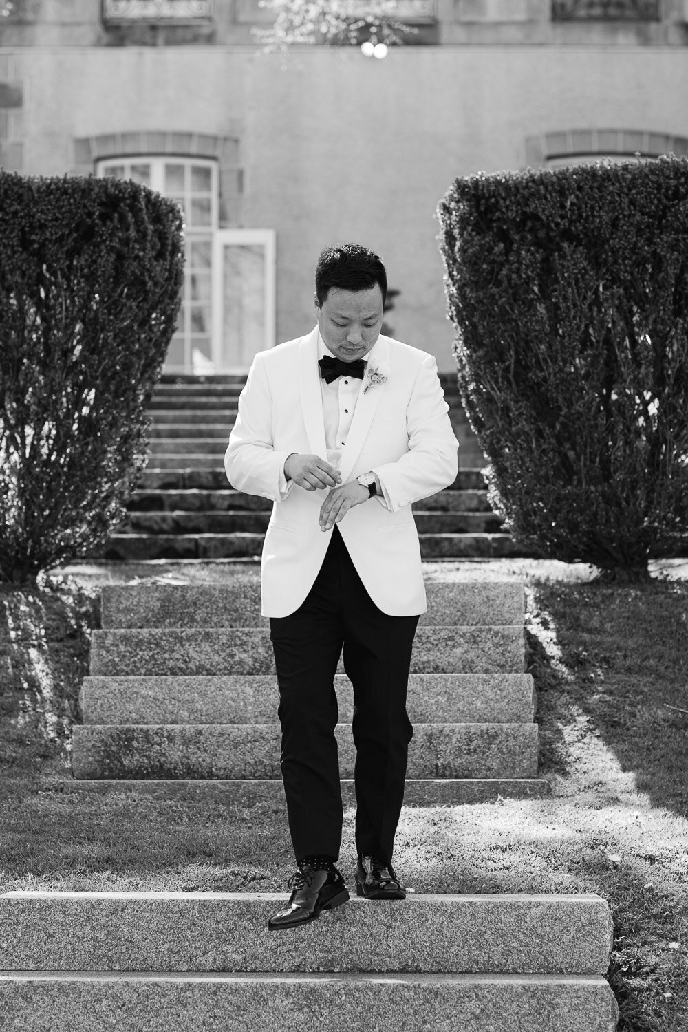 groom casual walk down steps looking at watch