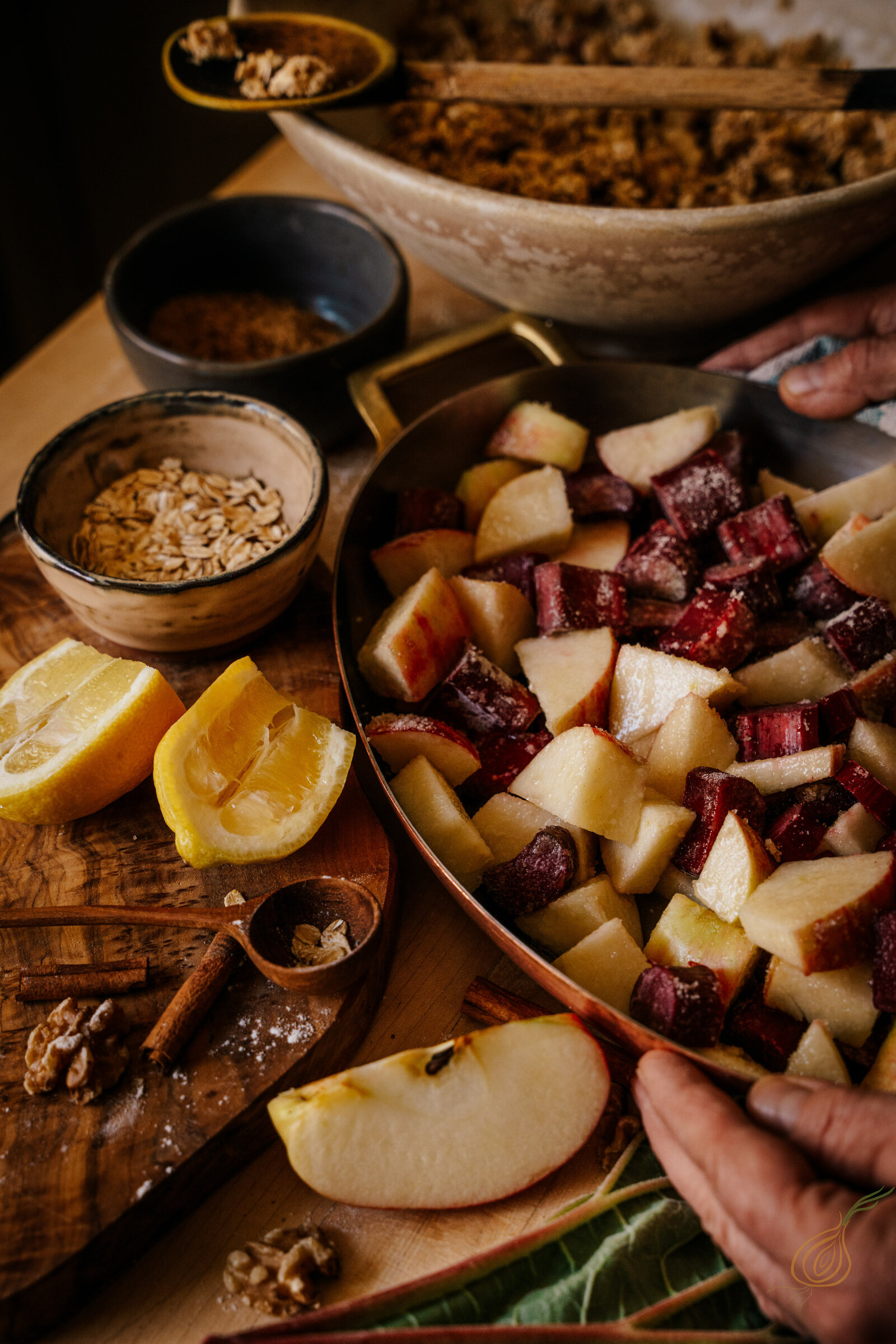 A pan filled with sliced apples, mixed nuts, and various ingredients, ready for cooking or baking.