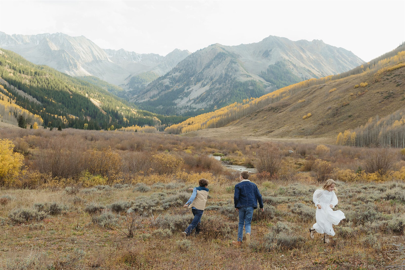 Editorial Aspen family photography — stylish family walking together in classic Ralph Lauren–inspired outfits.