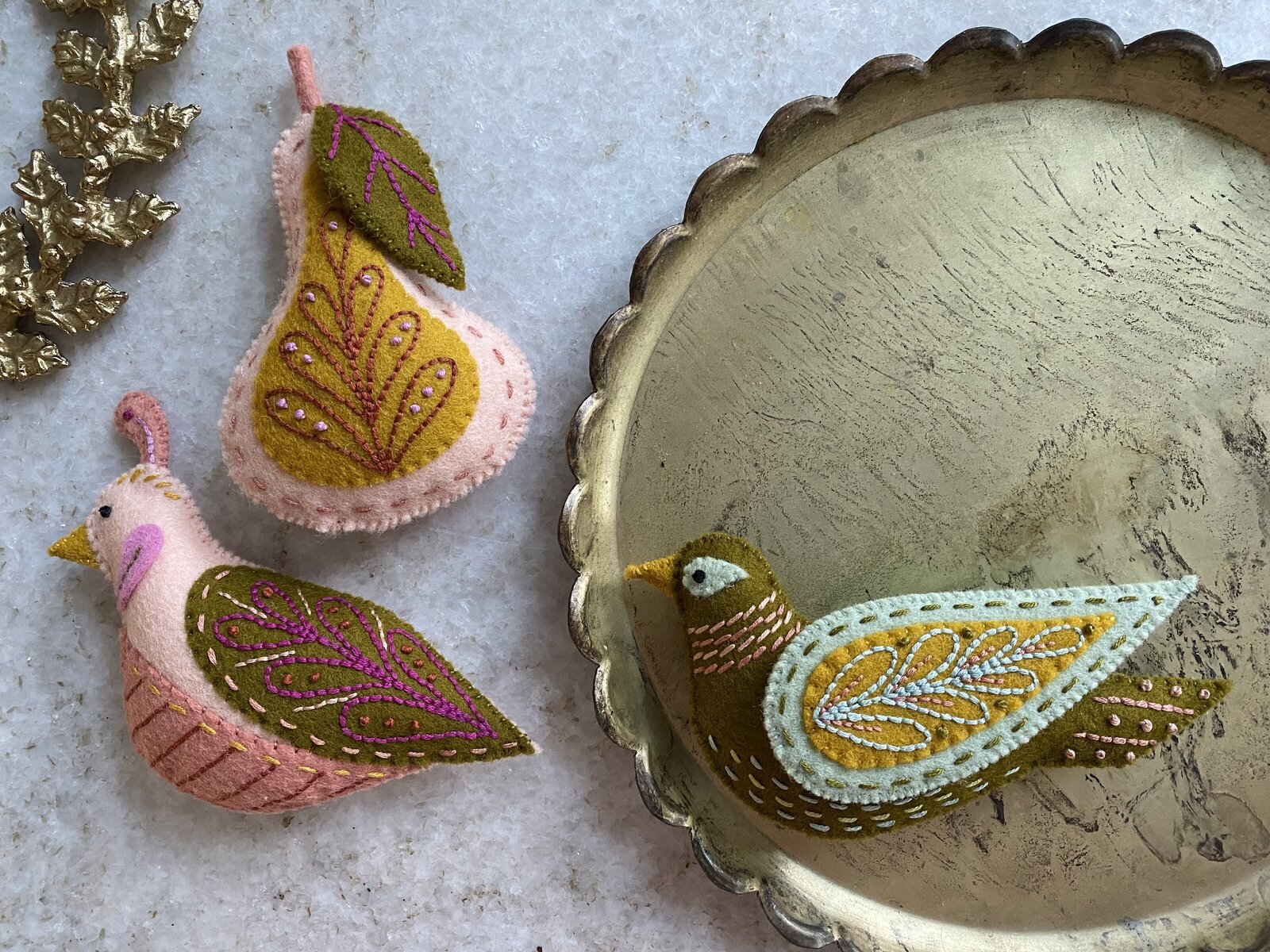 Two turtle doves and pear ornaments made out of felt.