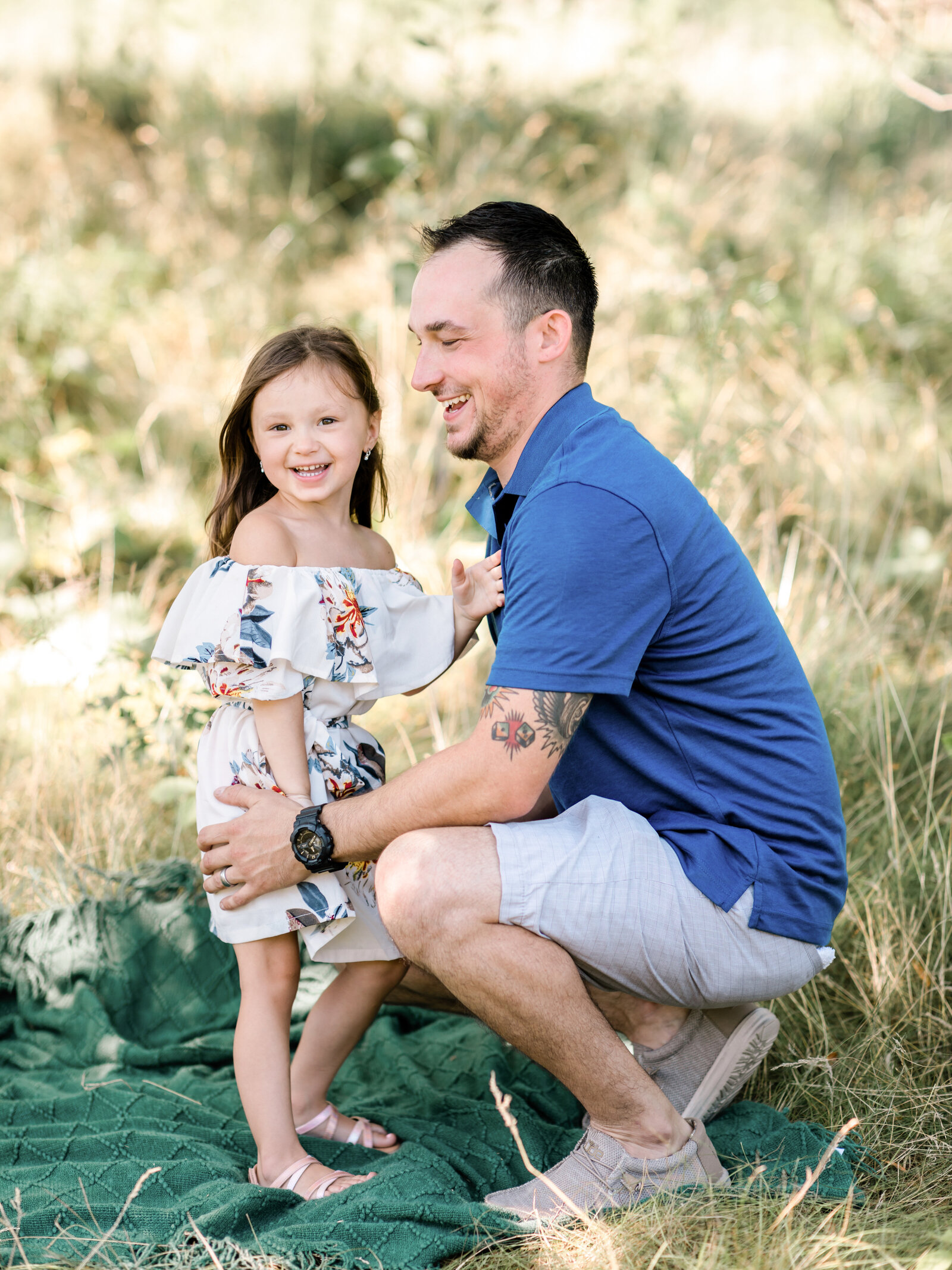 dad and daughter laughing for family photos