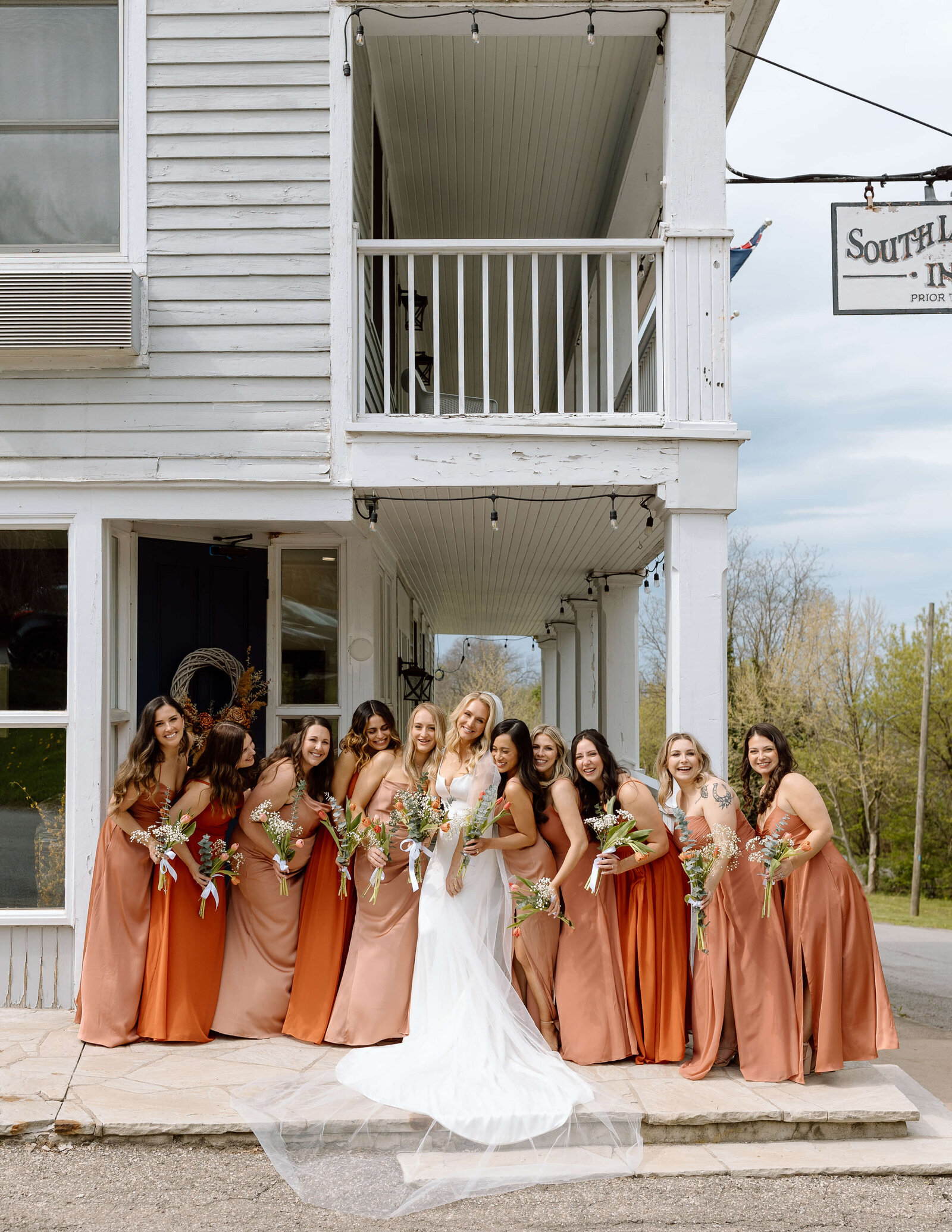 A bridal party standing outside of a hotel in Niagara On the Lake, Ontario
