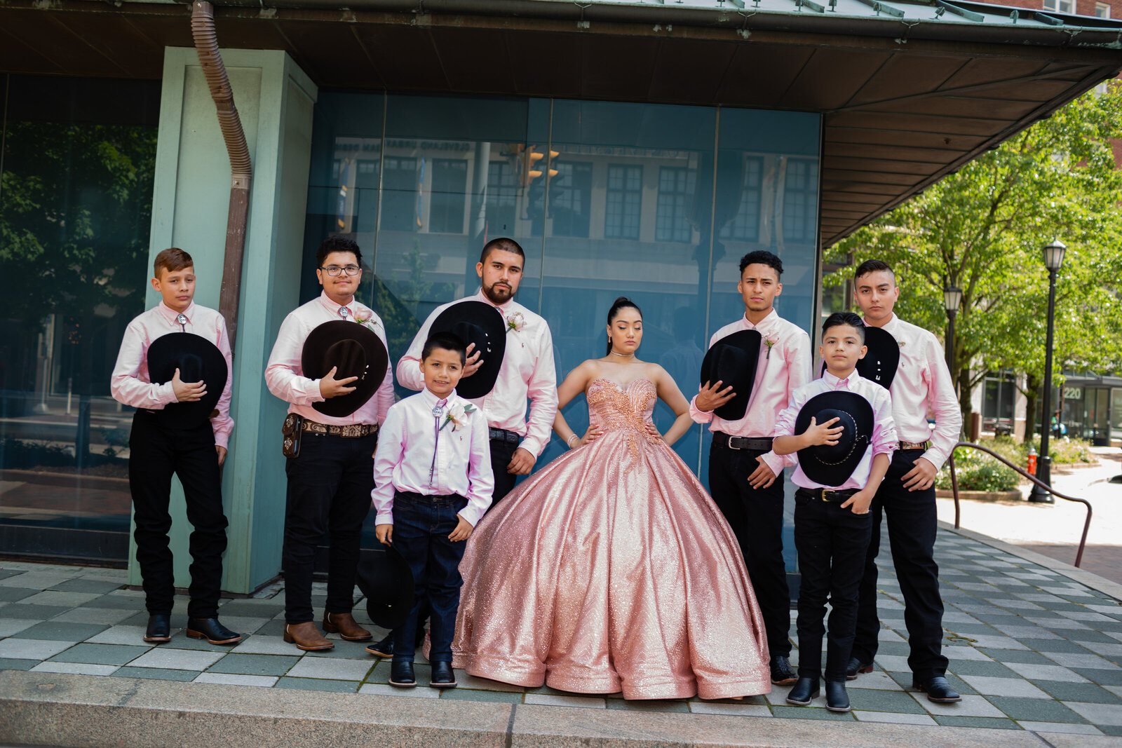 An elegant group portrait of the quinceañera with her chambelanes at Playhouse Square in Cleveland, Ohio. Capturing the formal charm and joyful celebration in this iconic location.