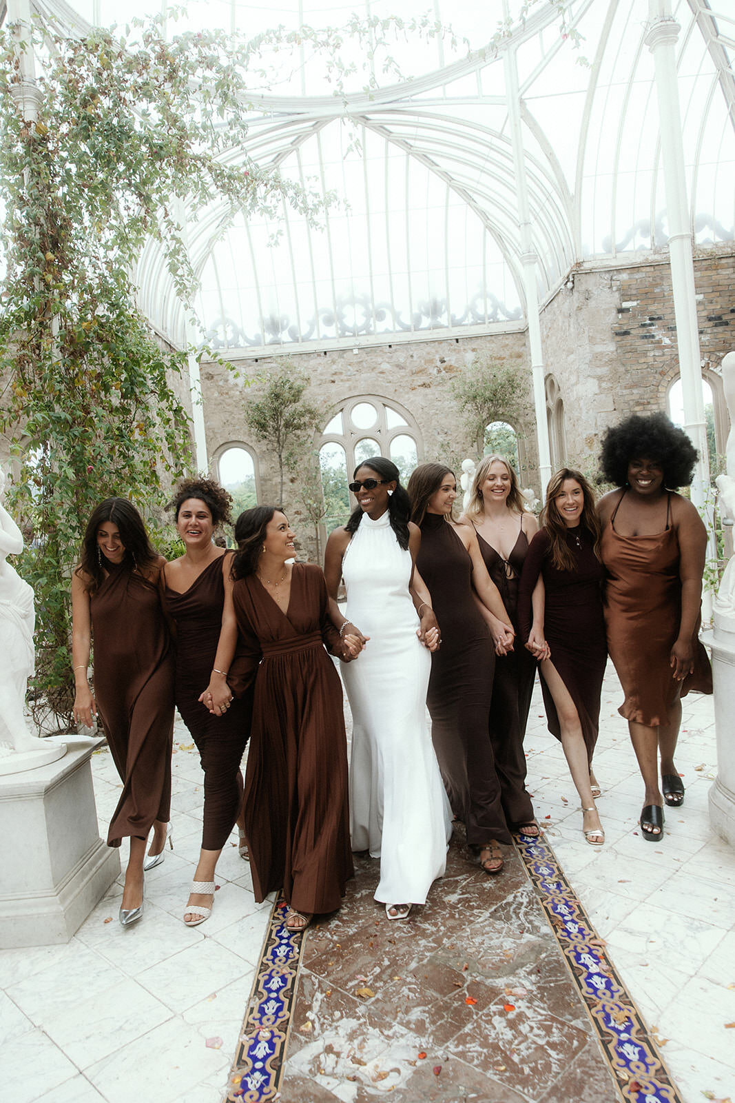 Bride and her bridesmaids walking towards the camera at Killruddery House and Gardens, Wicklow